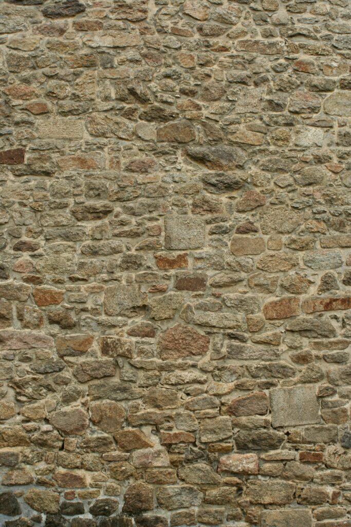 Close-up of a textured stone wall with varied rock compositions.